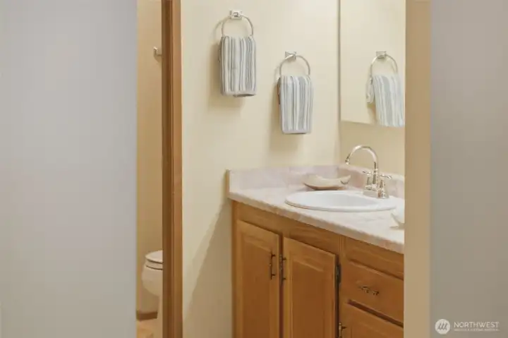 On the wall opposite the vanity, a door opens to the primary’s large, walk-in closet.