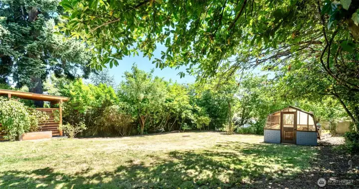 A lovely fully fenced yard and the coolest greenhouse. A lovely fully fenced yard and the coolest greenhouse.