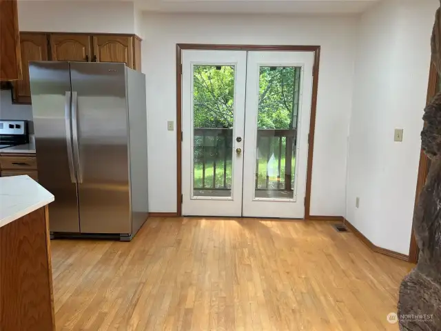 French doors leading from kitchen to side deck