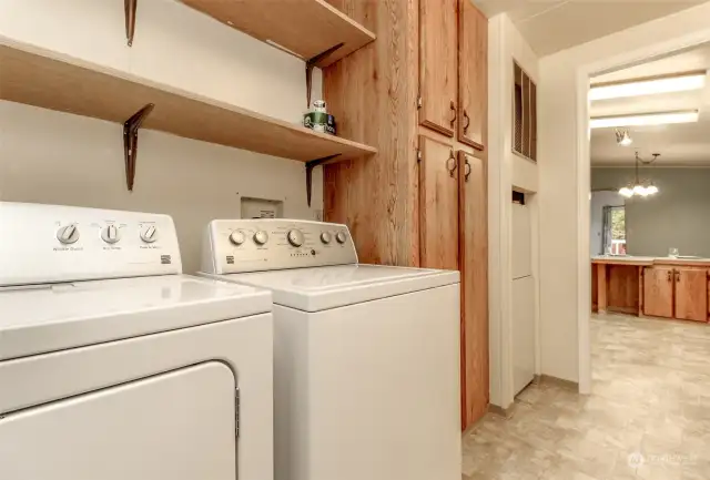 Washer and Dryer stay, extra cabinets for storage.