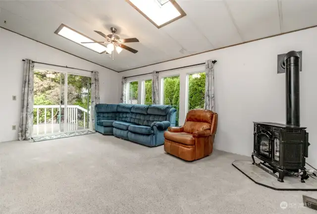 Large family room. The freestanding propane stove has never been used by the current seller. They are unaware of it it works.