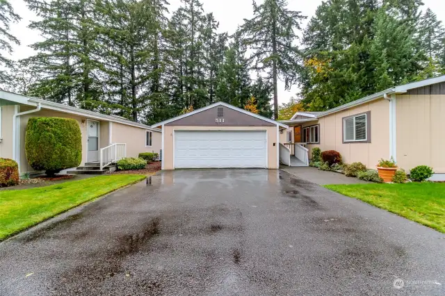 Ample parking in the driveway with sidewalk leading to wheelchair ramp and front door.