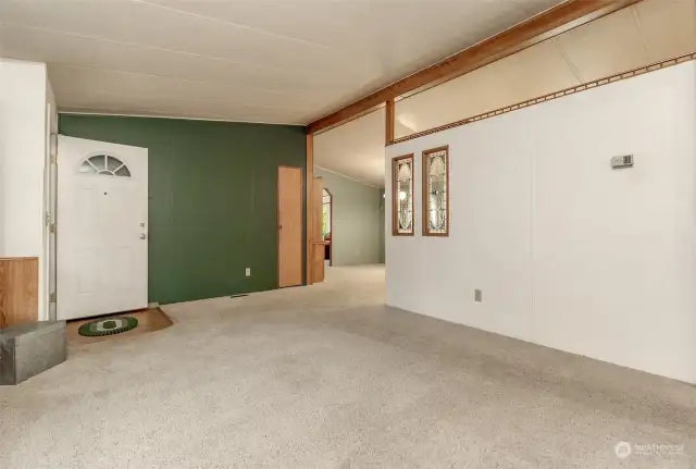 This angle from the living room faces the dining room and the kitchen is behind this wall to the right.