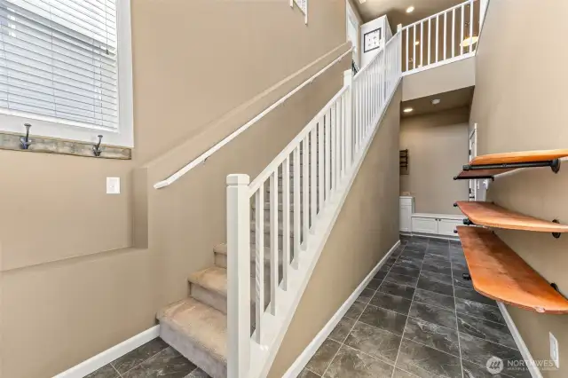 Entry to upstairs main living and are garage access.