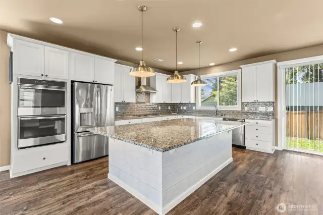 Heart of the home...DREAM custom kitchen with huge island and generous storage/counter space. Sit 6-8 bar stools.
