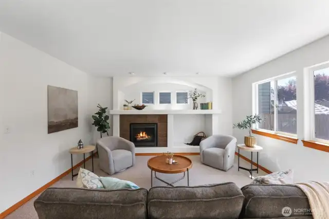 Den with fireplace and plenty of natural lighting