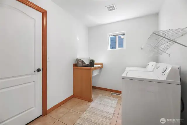 Laundry room downstairs that goes out to garage from Den area