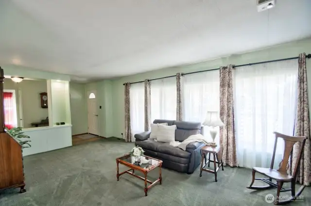 Wall of windows brings a light and airy feel to great room and entry.