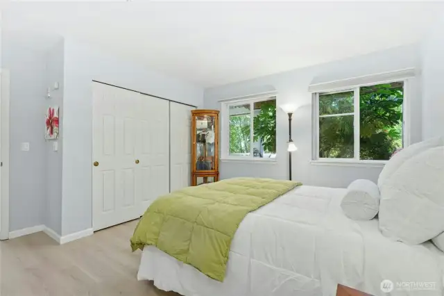 Primary Bedroom with huge closet and sunny windows that overlook the gardens