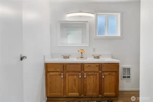 Double vanity in bath off primary bedroom. I can't say enough about the naural light in this home.