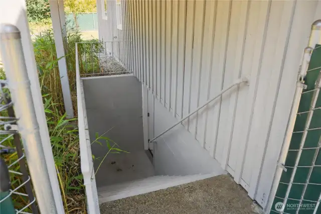 Seperate entrance for lower level of the home has shed roof covering for dry entry.
