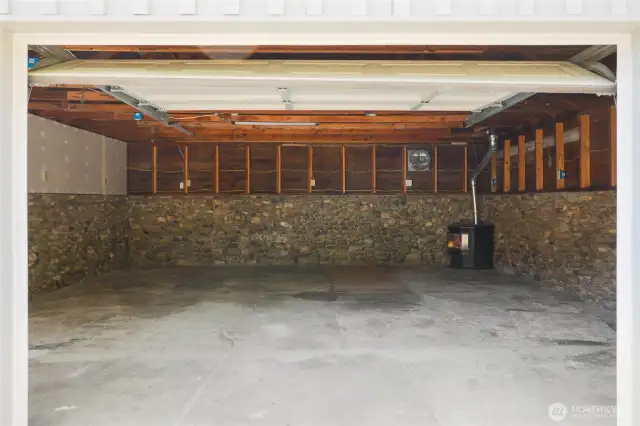 This feels like it could be more than a garage. It does have pellet stove heat and power. For the home mechanic is features a service pit.Love the rock skirting.