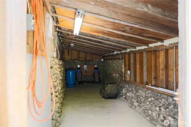 Private well secured here attached to the garage. Nice storage are and the well will service the home and additional water hook up at bonus area.