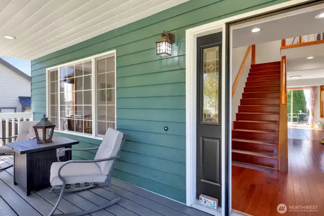 Northwestern-style exterior fixtures and soft recessed lighting set the perfect ambiance for relaxing evening retreats on the inviting front porch