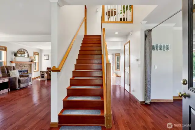 Entering into the home, the upper floor leads you to 3 bedrooms and 2 full bathrooms.  To the right, is an area for either a den/office or separate sitting area.  To the left is the large great room and down the hall is the 1/2 bath and kitchen and dining area.