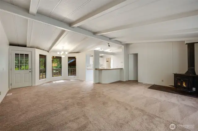 The living room flows to dining space and kitchen.