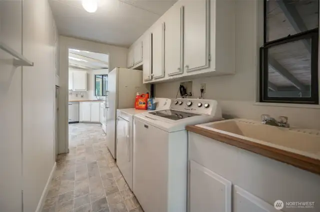The utility room is located off the kitchen and washer/dryer are included.