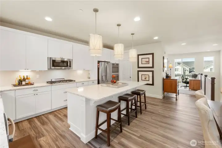 View of the kitchen leading to living room with upper deck.