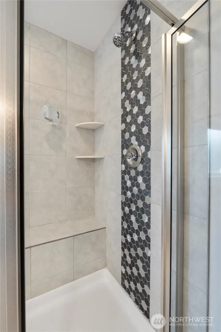 Primary shower with beautiful tile work.