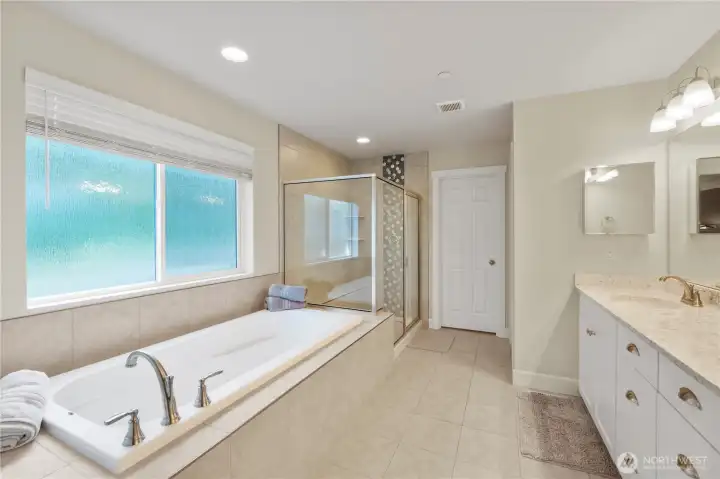Another picture of primary bath with large soaking tub & separate shower.