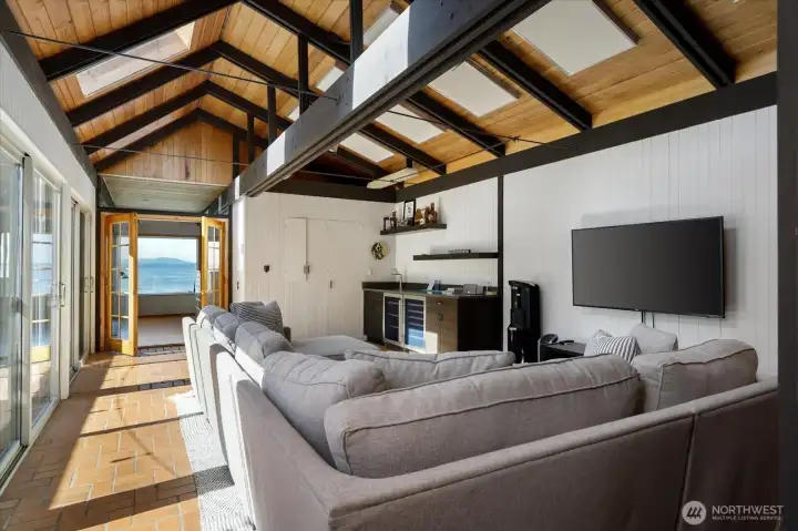Huge family room with vaulted ceilings, ideal for viewing ball games, evening movies, equipped with newer wet bar, storage, wine fridge. Tons of natural light throughout this home.