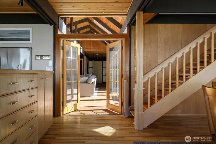 Stairs leading to upper primary suite, kitchen on your left is open to the dining area and living room with propane gas fireplace.
