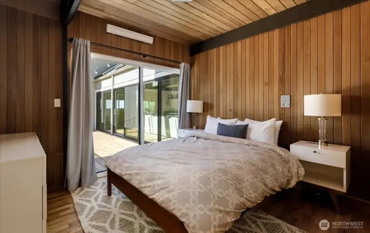 One of two main floor bedrooms off the main entry foyer, with sliders to central courtyard.