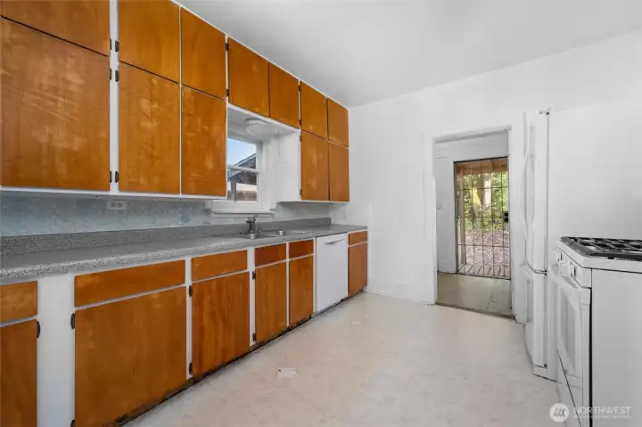 Kitchen has lots of storage and a gas range.