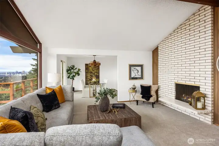 A period masonry fireplaces rises to the vaulted, open-beam ceiling.