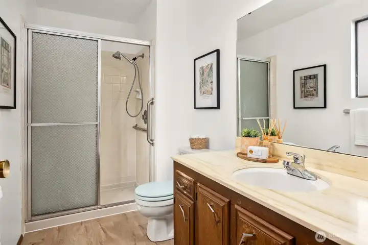 En-suite 3/4 bath with walk-in tile shower.