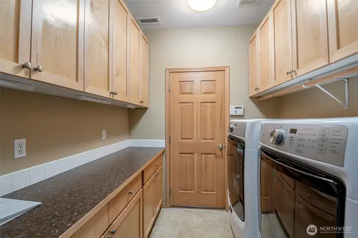 The laundry is convieniently located off the main hall and leads to the garage. More custom built-ins for more storage and the washer and dryer convey!