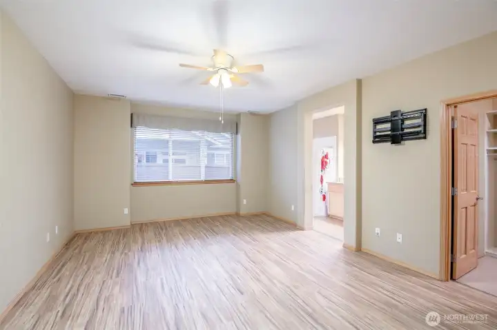 This primary suite has wonderful natural light, a 3/4 bath and built-in custom California Closet System.