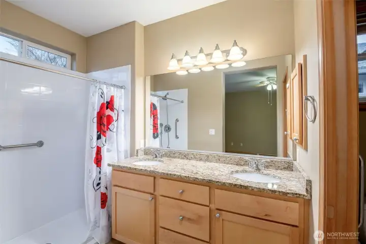 The primary bedroom ensuite bath features double vanities separated from the toilet room for added privacy.