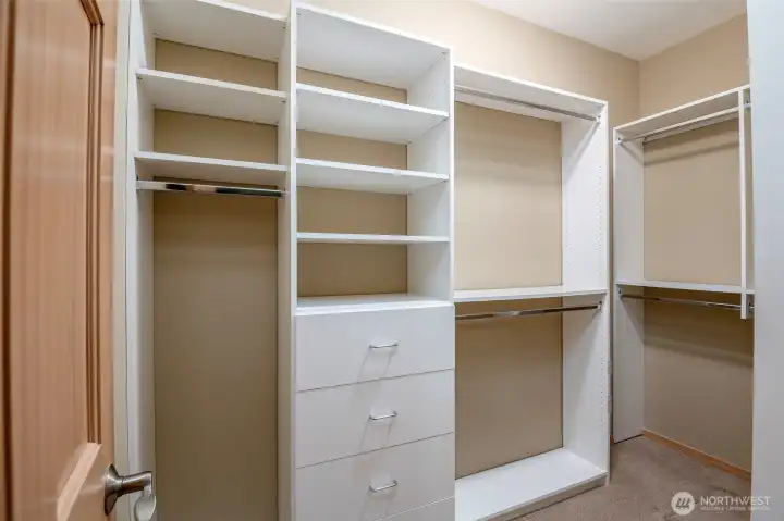 The primary bedroom features this beautiful custom California Closet System in the walk-in closet for maximum storage.