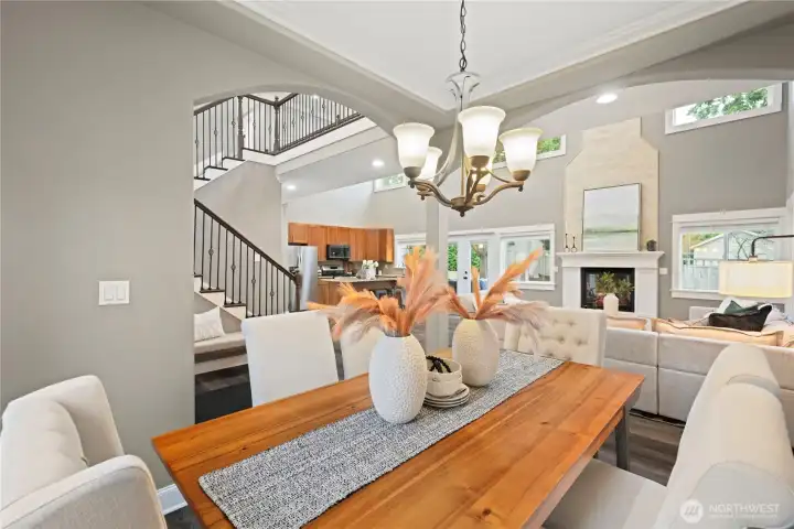 Another view from the dining room looking towards the great room, kitchen, and grand stairway that leads to a dramatic catwalk on the second floor.