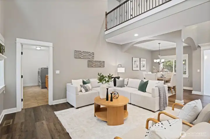 Comfortable great room with dining room in the back.  Door leads to the large laundry room and to the garage.