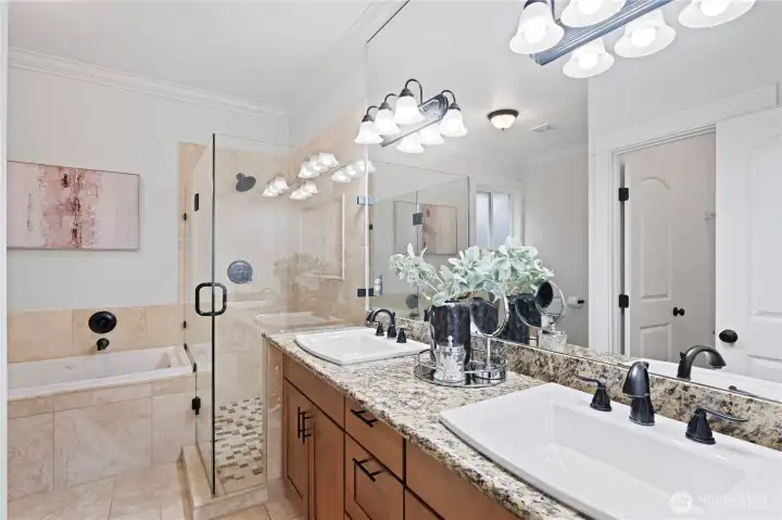 Primary suite bath with heated floors, double vanities, walk-in shower, separate jetted tub and commode with heated seats.