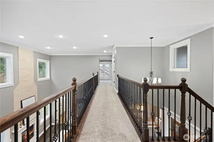 This dramatic catwalk leads to the privte office and generous bonus room.  Great views from here to the great room, dining room, and the front entry.
