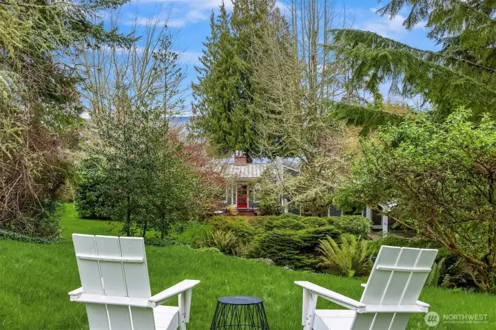 Front yard goes to neighbors fence post and past the laurel bush