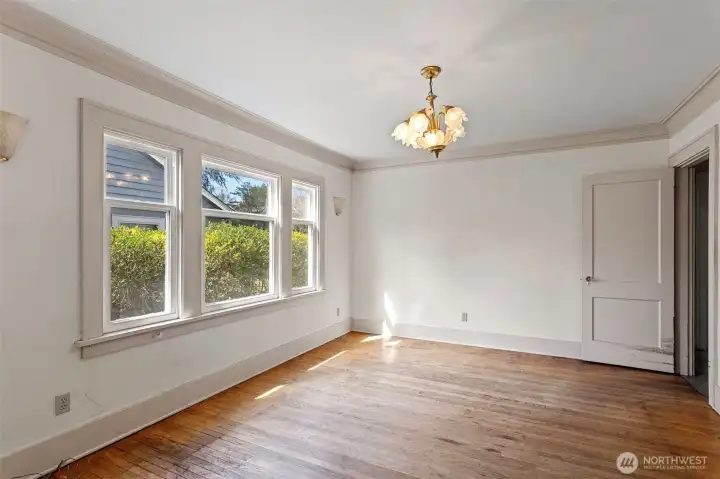 Spacious dining room with original crown molding, oak floors and picture windows which have been updated.