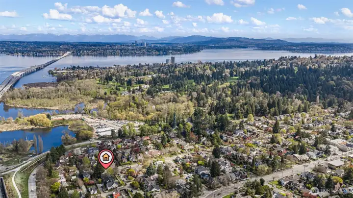 Looking east is Madison Park on the west side of Lake Washington, and the Bellevue skyline and Cascade mountains beyond.