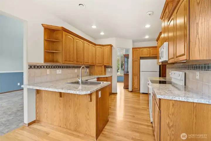 A very well laid out kitchen with storage galore!  Beautiful warm wood cabinetry, featuring pull outs, lazy susan, appliance garage.