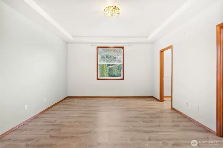 Primary bedroom features coffered ceilings, a huge walk in closet and ensuite with soaking tub.