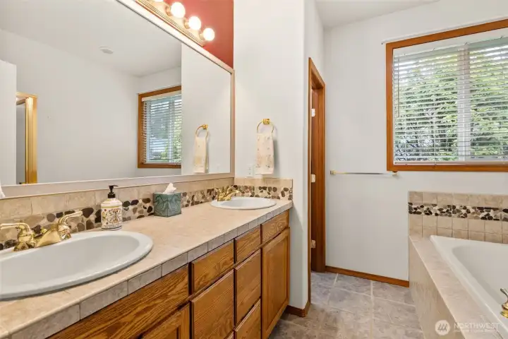 Primary ensuite with dual sinks, private water closet, soaking tub and shower.