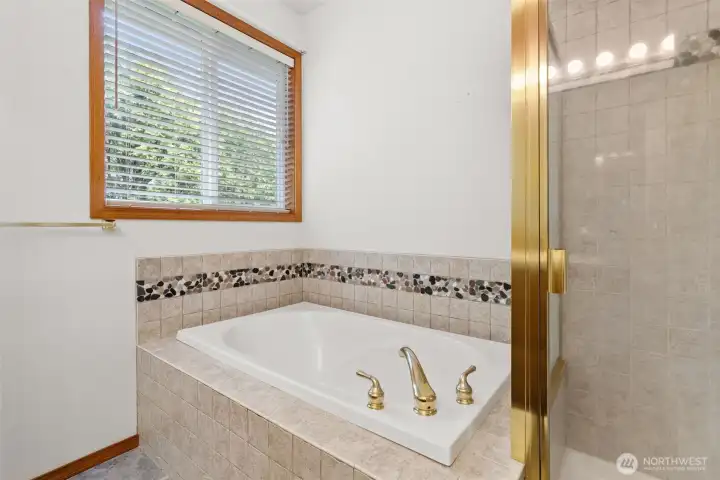 Primary ensuite with sumptuous soaking tub and separate shower.