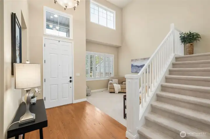 Entry with soaring ceiling welcomes you to the elegant living room.
