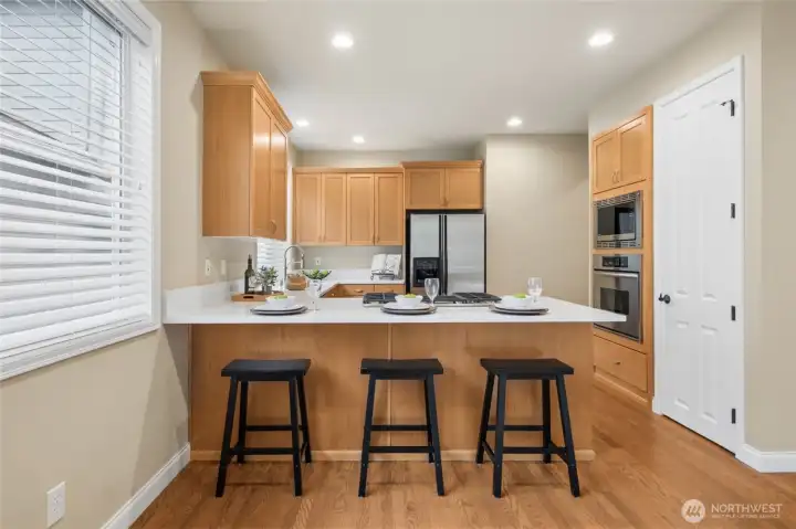 Dream kitchen features quartz counters, dining bar and stainless steel appliances