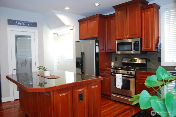 Real Brazilian cherry hardwood floors on the main level. The kitchen features granite counter tops, stainless steel appliances, gas range, butler's pantry, breakfast/dining area, and custom cabinetry accented with crown molding.