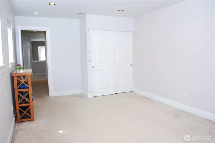 Looking across the bonus room back down the hall to the other bedrooms and bathroom.  Bonus room with a closet for a 4th bedroom or movie/hobby room.