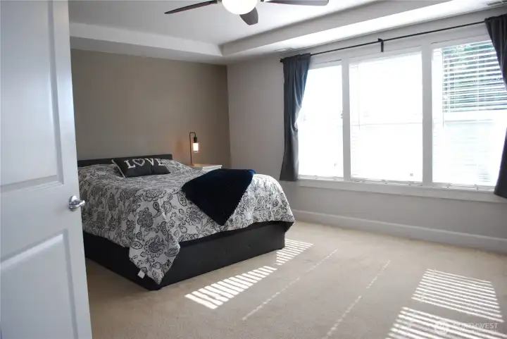 At the top of the stairs, French doors open to the primary suite.
